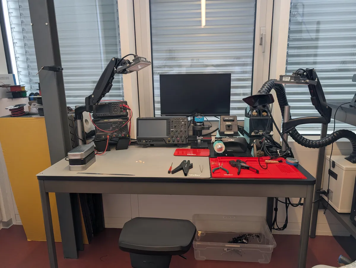 Full professional electronics workbench with instruments, soldering, and inspection tools.