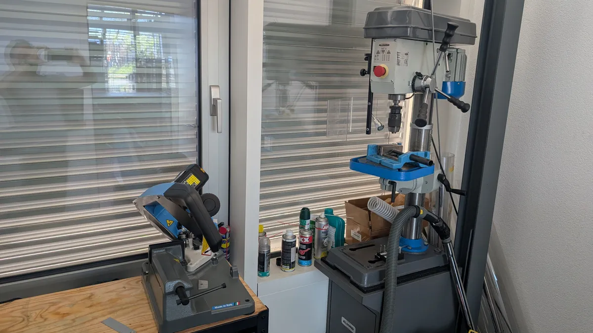 Drill press and metal cutting saw for mechanical fabrication.